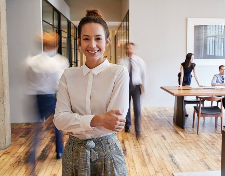 A woman with a buttoned shirt is smiling